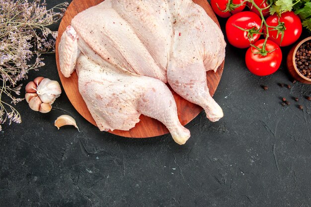 top view fresh chicken with tomatoes greens and seasonings