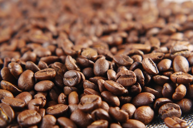 Top view of fresh coffee beans on black background with copy space