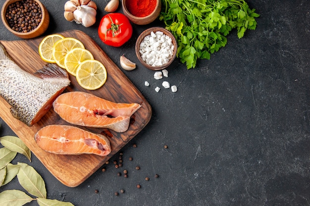 top view fresh fish with greens and lemon on dark background fish salad water ocean sea meal dinner seafood