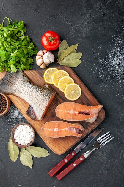 top view fresh fish with lemon and greens on a dark background meal salad seafood water fish meat sea ocean food