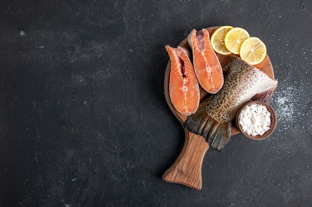 暗い背景にレモンスライスと新鮮な魚の上面図海のシーフード食事食品食事水肉サラダ海の魚