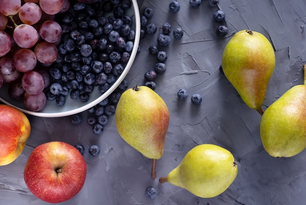 Top view of fresh fruits on a gray background