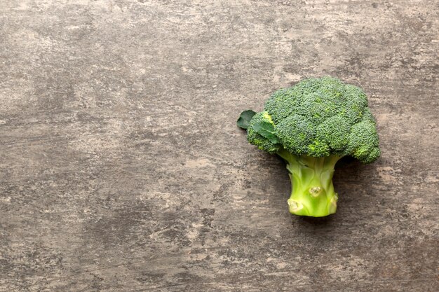 Top view fresh green broccoli vegetable on Colored background. Broccoli cabbage head Healthy or vegetarian food concept. Flat lay. Copy space