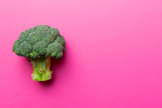 Top view fresh green broccoli vegetable on Colored background. Broccoli cabbage head Healthy or vegetarian food concept. Flat lay. Copy space