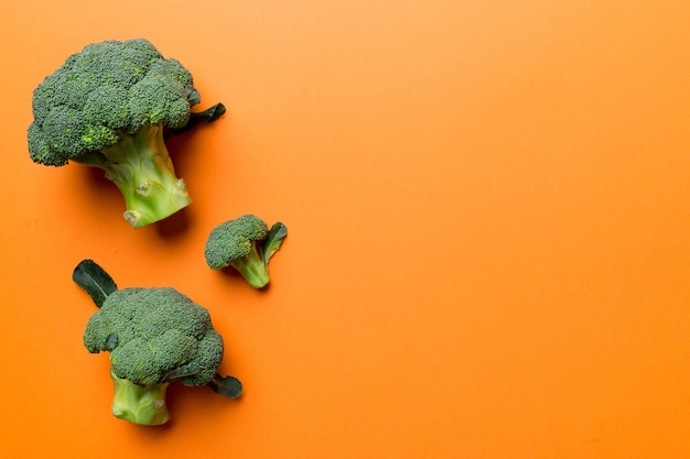 Top view fresh green broccoli vegetable on Colored background Broccoli cabbage head Healthy or vegetarian food concept Flat lay Copy space