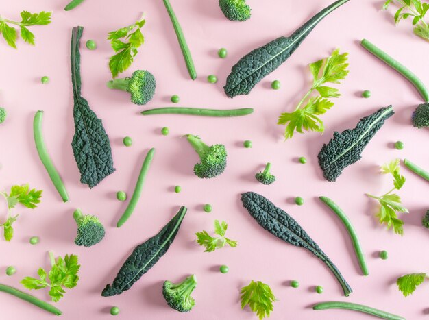 Top view of fresh green vegetables on the pink table