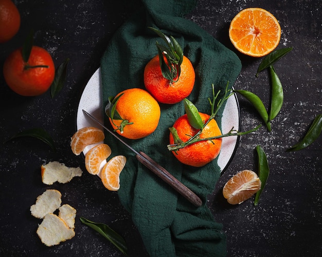 Top view of fresh mandarins on a dark table