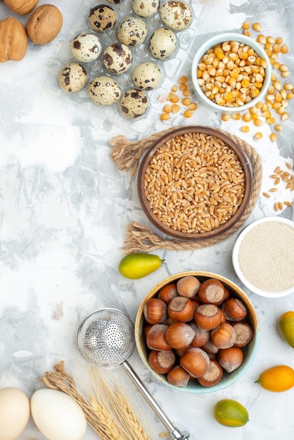 Top view fresh nuts with flour eggs and milk on a white background photo color cake pie hotcake bun biscuit dough