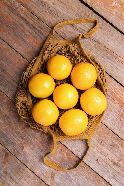 Top view of fresh organic oranges in string bag