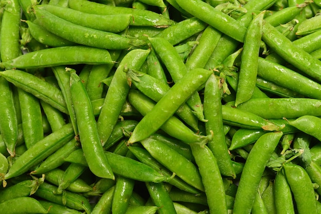 Top view fresh pea pods as background