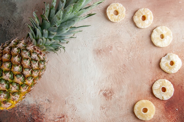 top view fresh pineapple dry pineapple rings on beige background with copy place