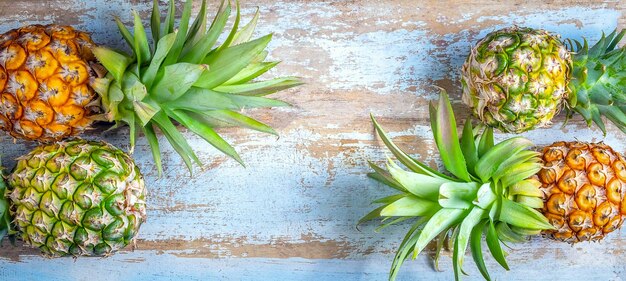 Top view of fresh pineapple fruit placed on an old wooden background