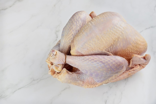 Top view of fresh raw turkey on a white surface