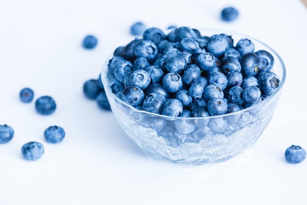 Top view of fresh ripe blueberries in bowl isolated on white