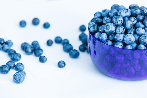 Top view of fresh ripe blueberries in bowl isolated on white