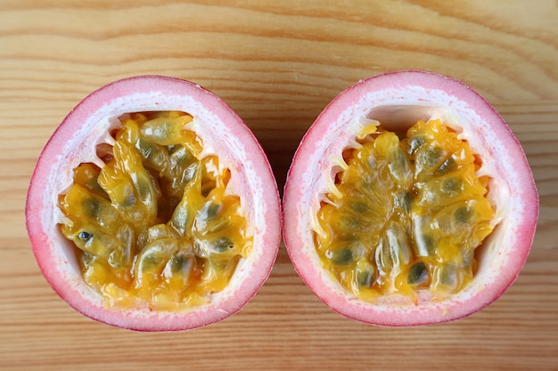 Top View of Fresh Ripe Passion Fruit Cut in Half Isolated on Wooden Table