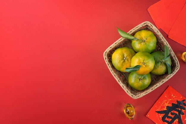 Top view of fresh ripe tangerine mandarin orange with fresh leaves. Chinese lunar new year fruit concept, the Chinese word means spring.