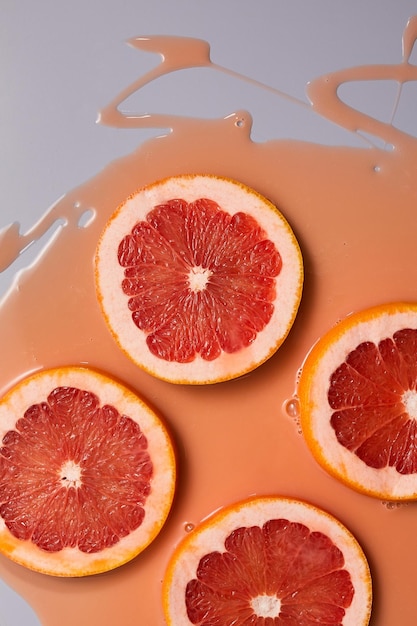 Top view of fresh slice grapefruits juice and gel serum organic cosmetics