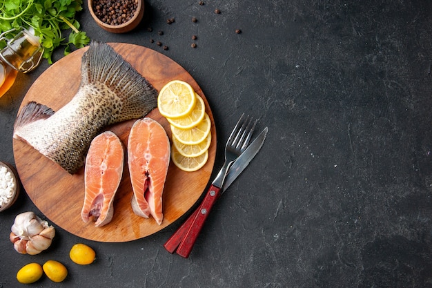 top view fresh sliced fish with lemon slices on dark background seafood meal ocean food meal salad water fish meat