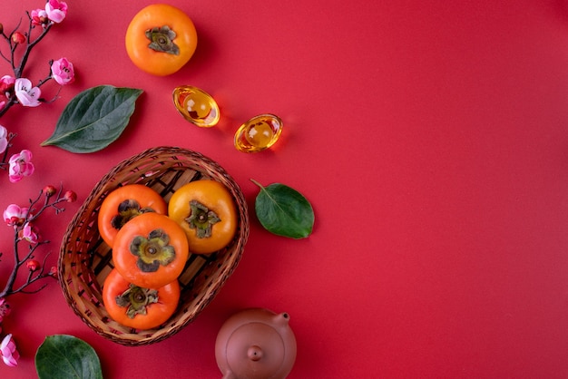 Top view of fresh sweet persimmons kaki with leaves. Chinese lunar new year.