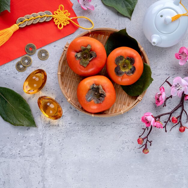 Top view of fresh sweet persimmons kaki with leaves. Chinese lunar new year.
