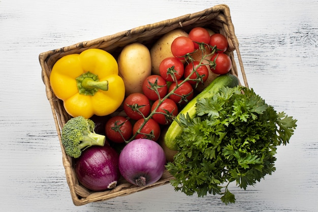 Photo top view fresh vegetables in basket