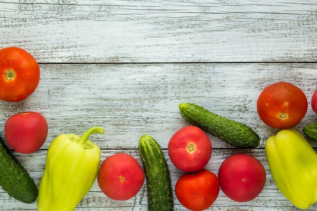 Top view of fresh vegetables and spices on light wooden table