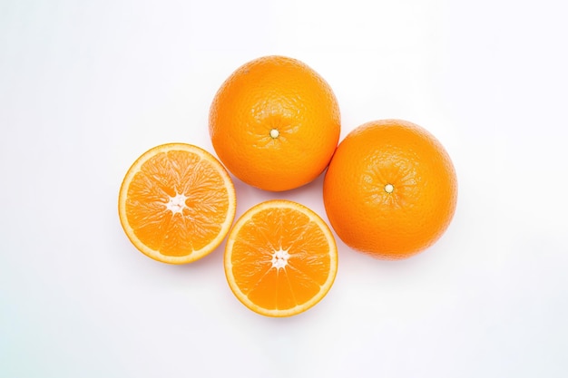 Top view of fresh whole and sliced oranges isolated on white background