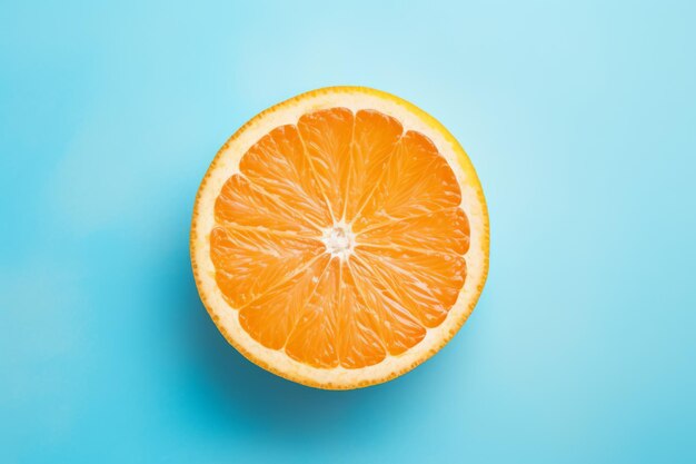 Top view of a freshly sliced orange on a pastel blue background