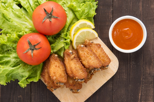 Top view fried chicken wings on wooden table