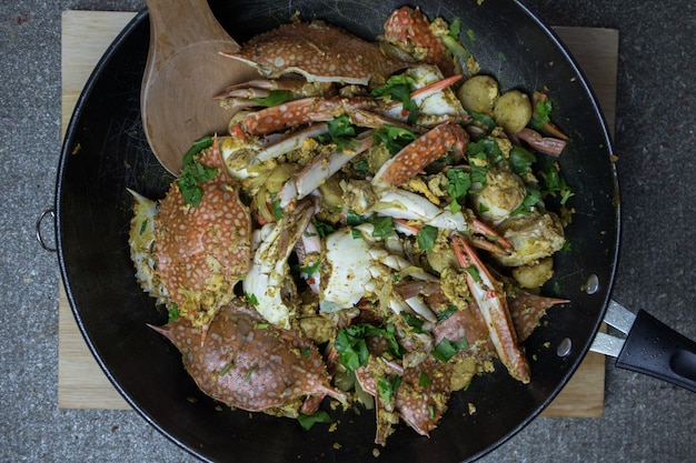 Top view of Fried crab with curry powder in a black pan