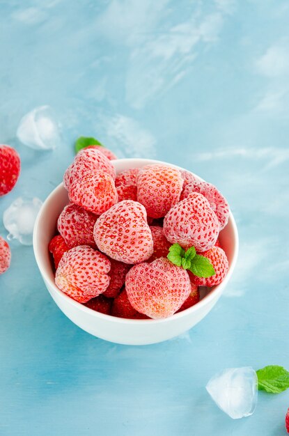 Top view of frozen strawberries in a bowl