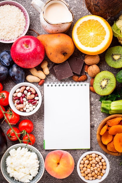 Top view fruits and vegetables with blank notebook