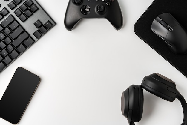 Top view of gamer table with computer keyboard joystick and headphones