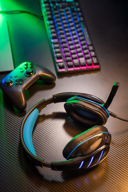 Top view of gamer workspace and gear headset mouse keyboard joystick VR on black table