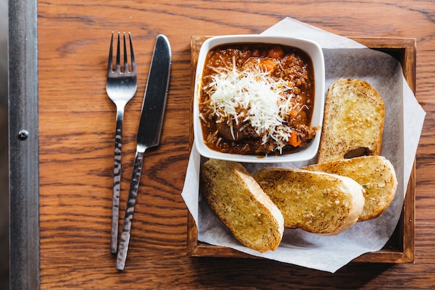 Top view of Garlic bread with meat sauce topping with mozzarella cheese.