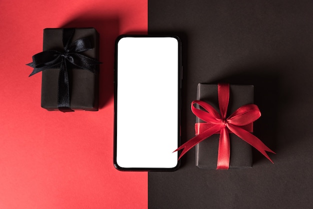 Photo top view of gift box wrapped in black paper and black bow ribbon