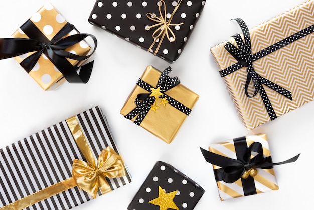 Top view of gift boxes in various black, white and golden designs. Flat lay. A concept of Christmas, New Year, birthday celebration event.