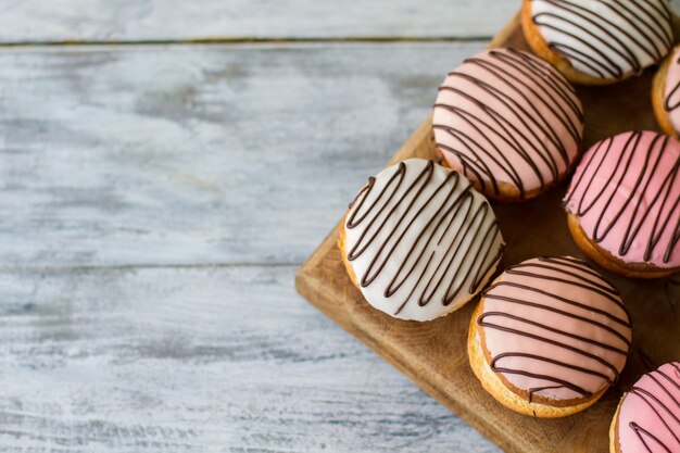 Top view of glazed biscuits. Cookies on wooden board. Bush cakes served at cafe. Freshly made pastry.