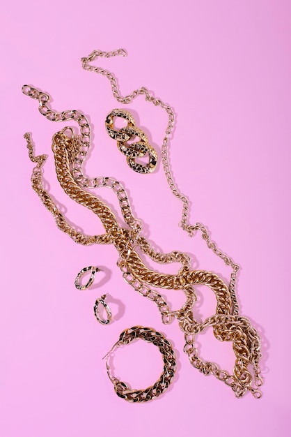 Top view on gold chains still life