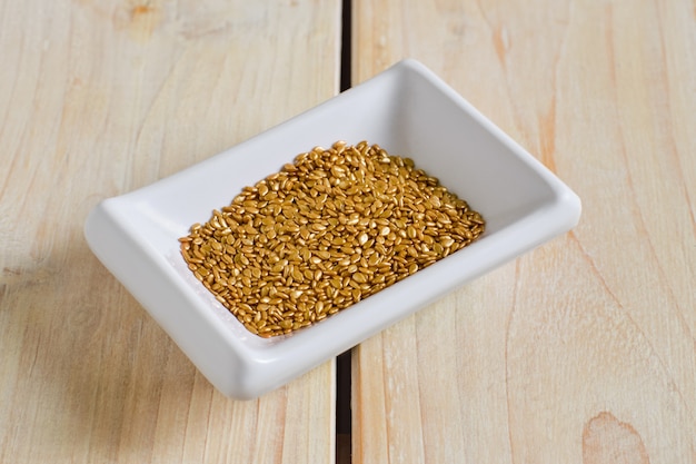 Top view of gold plated sesame seeds in ceramic bowl