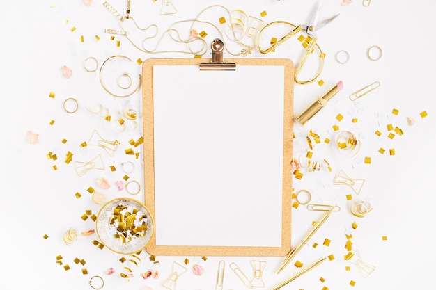 Photo top view on gold style feminine accessories clipboard