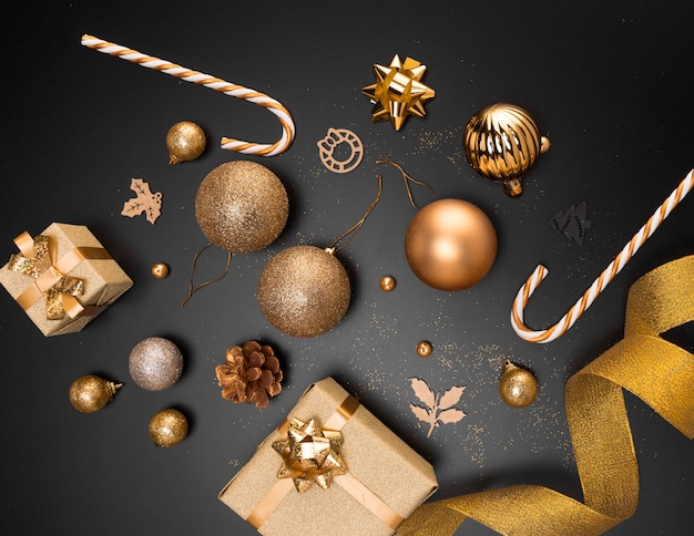 Top view of golden christmas ornaments with present