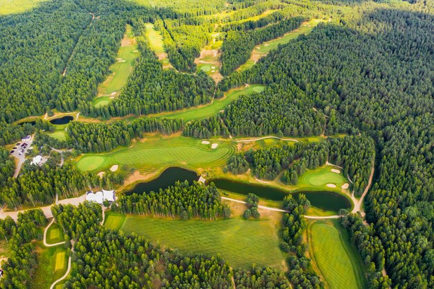 Top view of the golf course located in a wooded area