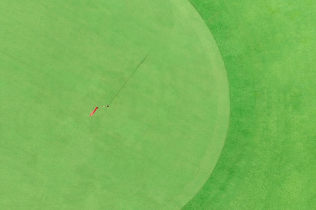 Top view of golf pole on the green in a golf course