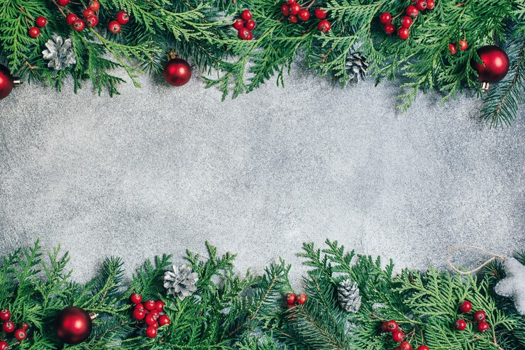 top view on gray background decorated with branches of a christmas tree with christmas decor