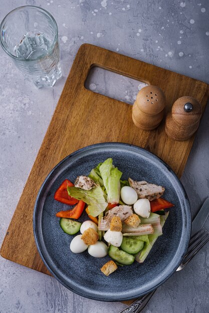 Top view greek salad on wooden cutting board