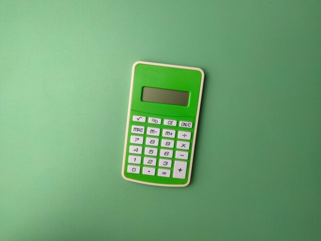 Top view green calculator on a green background