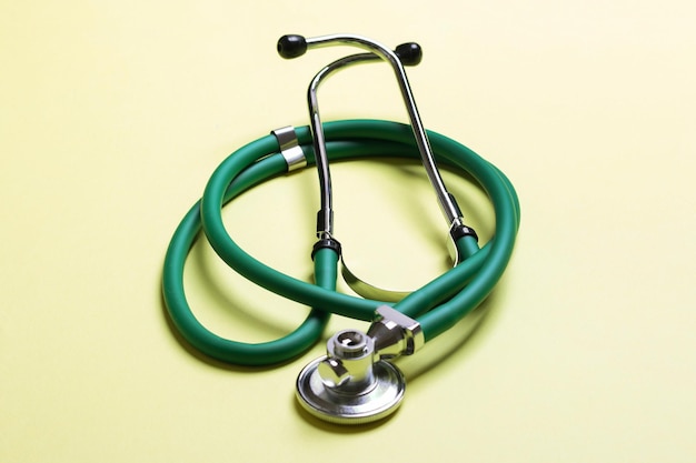 Top view of green medical stethoscope on colorful background with copy space Medicine equipment concept