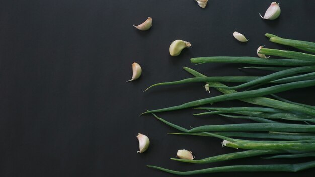 top view of green onions on dark background